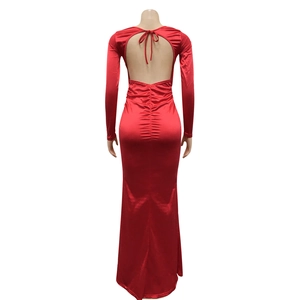 Elegant red long-sleeved backless maxi dress with a delicate bow tie and sleek glossy finish