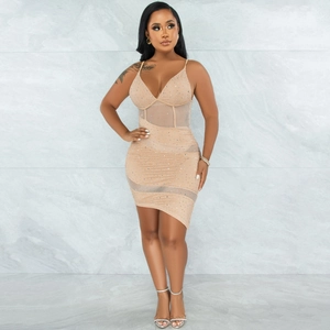 Detailed close-up of nude bodycon dress featuring sheer mesh panels and sparkling rhinestones