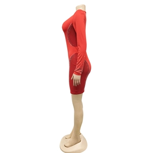 Detailed view of red bodycon dress featuring sparkling rhinestones on sleeves and sides
