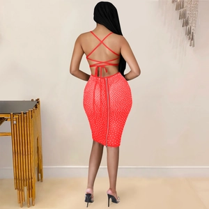 Detail of red backless party dress with rhinestone finish and crisscross straps