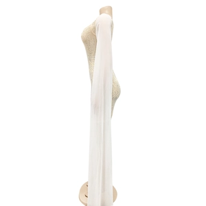 Detail of nude mesh bodycon dress featuring rhinestone patterns and long white chiffon sleeves