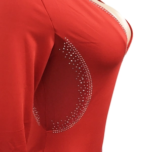 Detail of red dress with sheer mesh waist panel and sparkling silver rhinestones