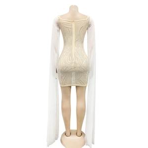 Detail view of rhinestone mesh dress with long sheer sleeves and back zipper closure