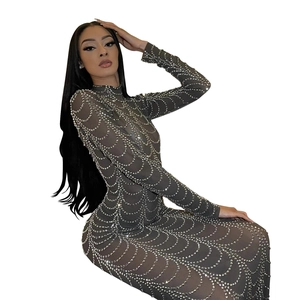 Detailed close-up of the sheer mesh fabric with silver rhinestones on the long sleeve dress