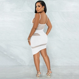 Detail of white mini dress featuring sheer mesh panels and sparkling rhinestone accents