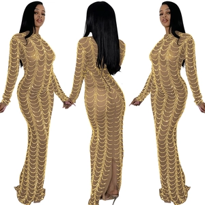 Detail of sheer mesh dress featuring intricate gold sequin chain patterns and slim fit