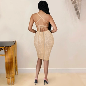 Detailed back view of backless bodycon dress with crisscross straps and sparkling rhinestones