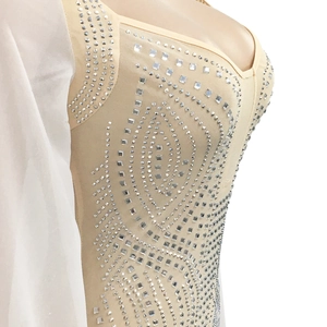 Close-up of mesh dress featuring silver rhinestones and elegant long cape sleeves