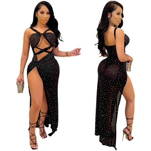 Close-up of black sheer mesh dress with rhinestones featuring high slit and cutout detail