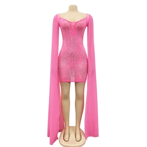 Close-up of hot pink rhinestone dress featuring long sheer mesh sleeves and sequin patterns