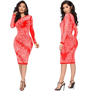 Close-up of red bodycon dress with long sleeves and sparkling rhinestone feather patterns