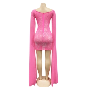 Detail of pink bodycon mini dress with silver rhinestones and long floor-length tulle sleeves