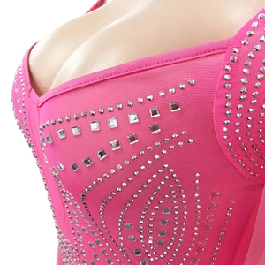 Close-up of hot-fix silver rhinestones on peach pink mesh fabric of a sexy evening dress