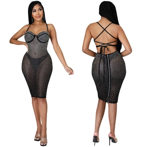 Detailed view of the backless crisscross strap design and sparkling rhinestones on the dress