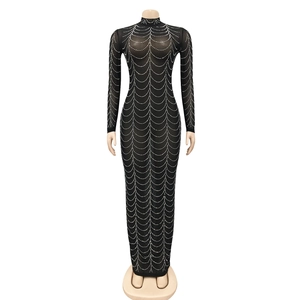 Close-up of black mesh dress featuring intricate rhinestone draped chain pattern details