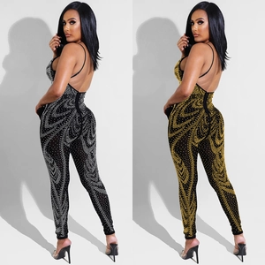 Detailed view of sheer mesh jumpsuit featuring shimmering rhinestones and open back design