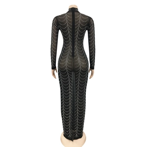 Close-up back view of sheer black mesh dress with rhinestone wave patterns and zipper detail