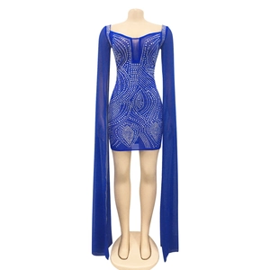 Detail of royal blue bodycon dress featuring rhinestone mesh and long floor-length cape sleeves