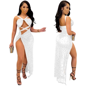 Detail of white mesh maxi dress featuring sparkling rhinestones and side slit