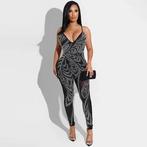 Detail of sexy black mesh jumpsuit with sheer pattern and sparkling white rhinestones