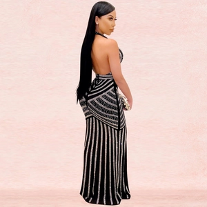 Detailed view of silver rhinestones forming geometric patterns on a black backless dress