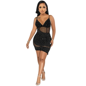 Detail of black rhinestone mini dress featuring sheer mesh patchwork and a sexy V-neckline