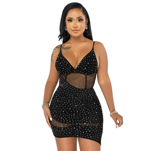 Detail showing sheer mesh panels and sparkling rhinestones on the black mini dress