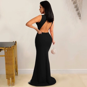 Close-up of the backless detail and side sequin embellishments on a black mesh maxi dress