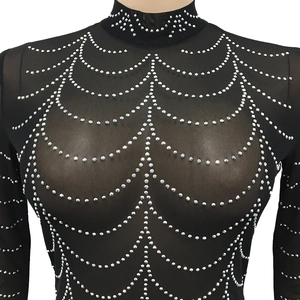 Detail of sheer black mesh top with sparkling silver rhinestones in draped patterns