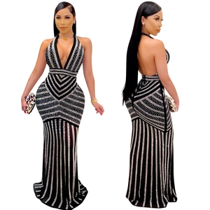 Detail of elegant V-neck evening gown featuring silver rhinestones on black mesh fabric