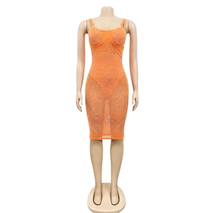 Detail van de oranje bodycon jurk met zilveren strassteentjes en dunne schouderbandjes