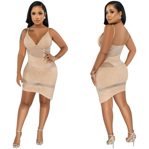 Close-up of nude bodycon dress featuring sheer mesh panels and sparkling rhinestone accents