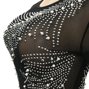 Detail of sheer black mesh top with intricate faux pearl and rhinestone embellishments