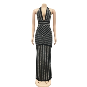 Detail of a black backless gown with sparkling rhinestones and a deep V-neckline
