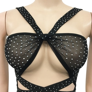 Close-up of black mesh fabric with sparkling rhinestones and crisscross strap detail