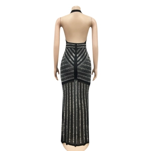 Detailed back view of a black halter maxi dress with silver rhinestones and sheer hem