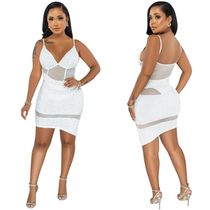 Detail of white mesh dress featuring shimmering rhinestones and a deep V-neck design