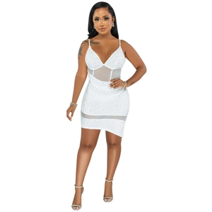 Detail of white bodycon dress featuring mesh panels and shimmering sequins on stretch fabric