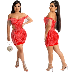 Detail of red off-shoulder mini dress with silver rhinestone fringe and waist cut-outs
