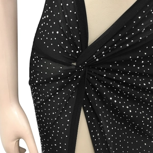 Close-up of black mesh dress featuring silver rhinestones and front twist knot detail