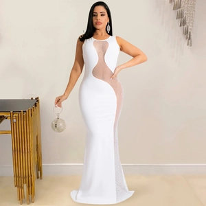 Close-up of sparkling rhinestones and sheer mesh panel on white bodycon dress
