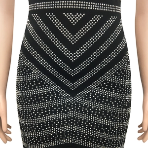 Detail of black dress with glittering silver rhinestones in a V-shaped chevron pattern