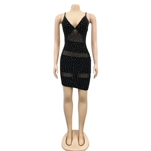 Detail of black V-neck mini dress with silver rhinestones and sheer mesh panels