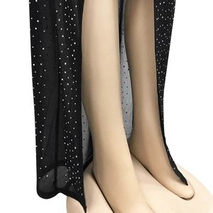 Detail of black sheer mesh fabric with silver rhinestones and sexy side slit design