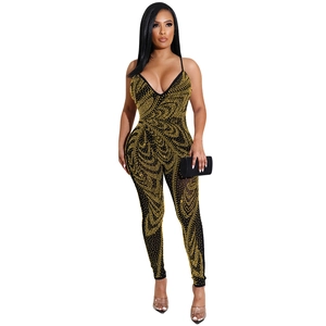 Sexy black bodycon jumpsuit with gold rhinestone patterns and sheer mesh details