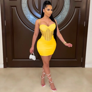 Sexy bright yellow bodycon mini dress with rhinestone corset and sheer mesh paneling