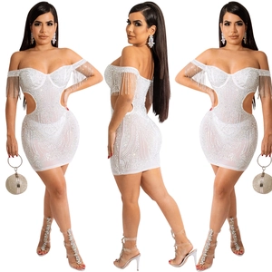 Detail of white rhinestones dress with fringe sleeves and waist cutouts on white background