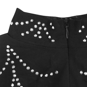 Detail of black mesh dress featuring silver rhinestones and a high collar with back zipper