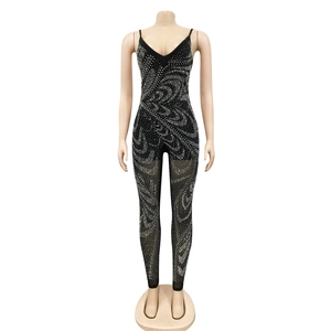 Detail of black rhinestone jumpsuit featuring a deep V-neck and sparkling spiral patterns