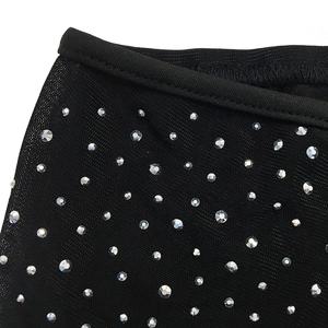 Detailed view of black mesh fabric with sparkling silver rhinestones and elastic edging
